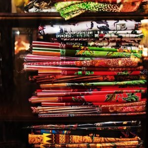 A Stack of Assorted Fabrics on Shelves